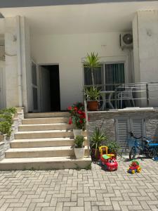 a house with stairs and plants in front of it at Liza's apartment 1f in Skataj +6 photos