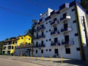 a building with balconies on the side of it at Flats e Apartamentos Dell Mar Locações in Ubatuba +27 photos