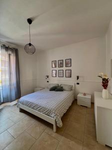 a bedroom with a bed in a white room at La camera a due passi dal mare in San Terenzo +1 photo