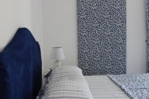 a bedroom with a bed with blue pillows at Casa Blu Cobalto in Maiori