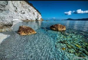 two rocks in the water on a beach at L'Amica di Napoleone Elba island in Portoferraio +23 photos