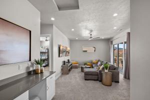 a living room with a tv and a couch at Ocotillo Springs 67 Low Prices, Private Hot Tub, Pool, Basketball Arcade, Ping Pong and Community Pool in Santa Clara