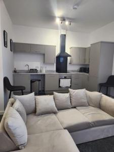 a living room with a couch and a kitchen at Home away from Home in Burton upon Trent