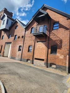 a brick building with a balcony on the side of it at Home away from Home in Burton upon Trent