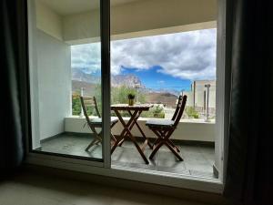 a table and chairs on a balcony with a view at Agaete Sunset in Agaete
