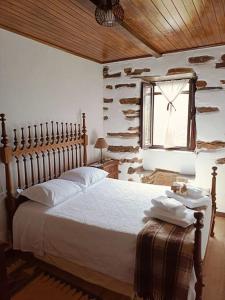 a bedroom with a large bed and a window at Casa dos avós 23 in Castro Daire +145 photos