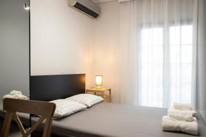 a bedroom with a large bed and a window at Dimo's Apartment in Litochoro