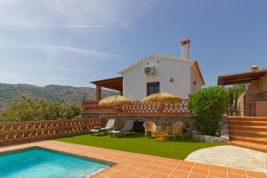a villa with a swimming pool and a house at Villa Castillo in Frigiliana