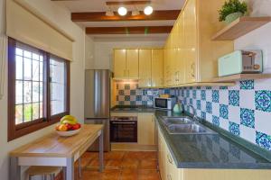 a kitchen with a bowl of fruit on a counter at Villa Castillo in Frigiliana