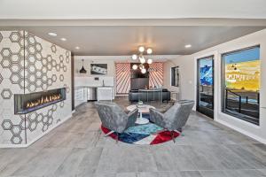 a living room with two chairs and a fireplace at Walkable Wonder Midtown Studio near Downtown Gems in Reno