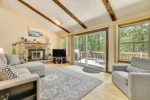 a living room with two couches and a fireplace at Clifton Township Home with Deck and Heated Sunroom! in Gouldsboro