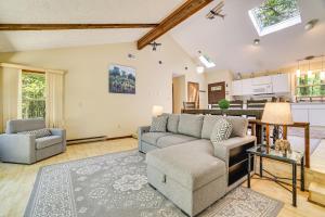 a living room with a couch and a table at Clifton Township Home with Deck and Heated Sunroom! in Gouldsboro