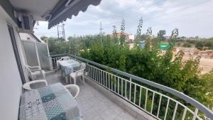 a balcony with a table and chairs and a view of a street at Makis Apartments Flogita in Flogita