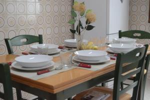 a dining room table with plates and dishes on it at Casa La Parra in Tejeda