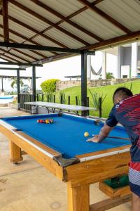 a man standing in front of a pool table at Finca Amarelo casa campestre cap 35 pers in Cali