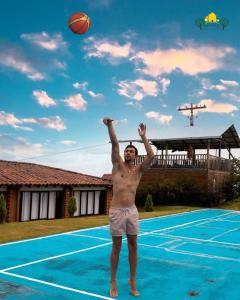 a man playing with a basketball on a basketball court at Finca Amarelo casa campestre cap 35 pers in Cali