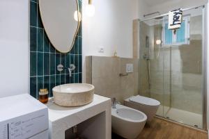 a bathroom with a sink and a toilet and a mirror at Hygge al Conero - Marcelli in Marcelli +26 photos