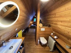 a wooden bathroom with a sink and a toilet at Résidence Le Flocon Ii - CHALET LE FLOCON Tout inclus MAE-1361 in Vars
