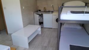 a room with two bunk beds and a sink at Studio Apartment Sanja 3 in Neum