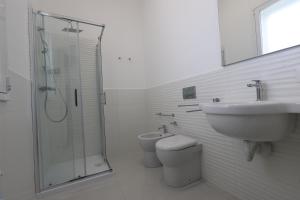 a bathroom with a sink and a toilet and a shower at B&B La Dea in Marzamemi
