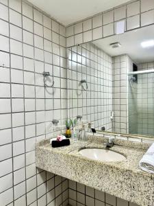 a bathroom with a sink and a mirror at (604) Studio encantador - Perto da praia in São Luís