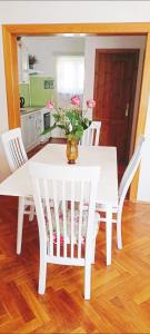 a white table and chairs with a vase of flowers at Ohrazenice 103 in Turnov