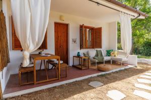 a patio with a couch and a table and chairs at Hygge al Conero - Marcelli in Marcelli