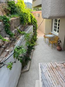 a patio with a table and chairs and plants at Parakladi unique stay in Agios Nikolaos