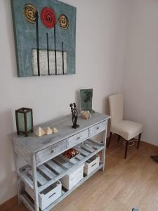 a room with a table with a chair and a painting at El Marques 28 by emepas in Logroño +15 photos