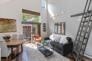 a living room with a couch and a table at Luxury Condo - Open for Bluegrass in Telluride +14 photos