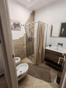 a bathroom with a shower and a toilet and a sink at Holiday House in Nardò