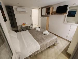 a small room with a bed and a table at Holiday House in Nardò