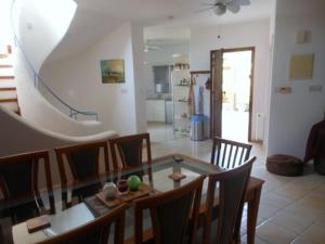 a dining room with a glass table and chairs at Villa Samantha in Paphos