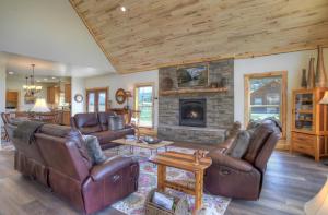 a living room with leather furniture and a fireplace at MountainAire in South Fork, CO in South Fork