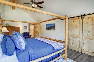 a bedroom with a bed and a ceiling fan at MountainAire in South Fork, CO in South Fork