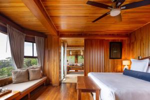 a bedroom with a bed and a ceiling fan at Hotel Belmar, a Member of Design Hotels in Monteverde Costa Rica +112 photos