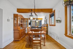 a kitchen and dining room with a wooden table and chairs at Picturesque & Serene Gem in Port Credit - Steps to Lake - Backyard in Mississauga +19 photos