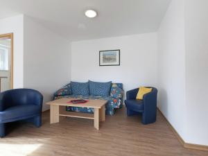 a waiting room with two chairs and a table at Spacious Apartment near Forest in Bad D rrheim in Bad Dürrheim