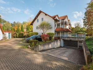 a house with a car parked in the driveway at Spacious Apartment near Forest in Bad D rrheim in Bad Dürrheim