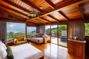 a bedroom with a bed and a balcony at Hotel Belmar, a Member of Design Hotels in Monteverde Costa Rica