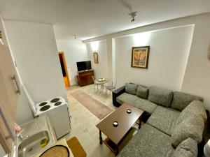 a living room with a couch and a table at Apartman MyHome Travnik in Travnik
