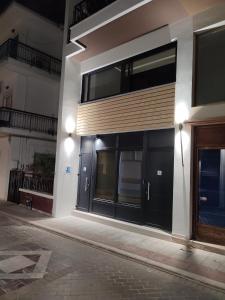 een gebouw met zwarte deuren en ramen 's nachts bij Kiani Akti Suites 2 in Preveza