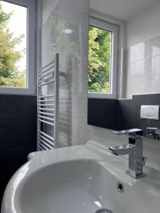 a white bathroom with a sink and a mirror at Royal Racing Suite Top 1 near Red Bull Ring in Judenburg +19 photos