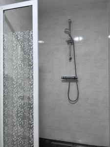a shower in a bathroom with a glass door at Royal Racing Suite Top 1 near Red Bull Ring in Judenburg