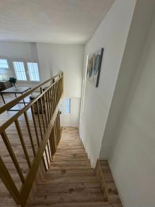 a hallway with a wooden staircase in a house at Park Hotel Tirana in Tirana