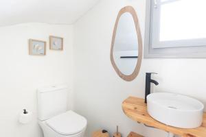 a bathroom with a white toilet and a mirror at Swell S1 maisonette in Naousa in Naousa +31 photos