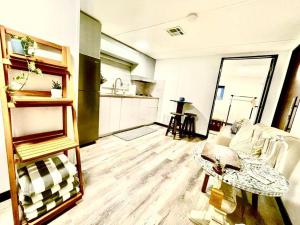a living room with a couch and a kitchen at La Colina House in Santana +24 photos