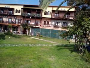 an apartment building with a lawn in front of it at Porto Kalliali in Ouranoupoli