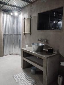 a bathroom with a bowl sink on a counter at Okuti Kwa Dala Self-Catering Accommodation in Okatana