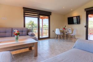 a living room with a couch and a table at Papi's free parking Villa in Alexandroupoli